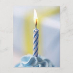 Cupcake with candle, close-up (focus on flame) postcard