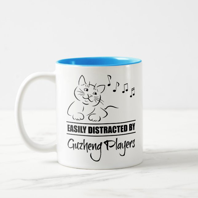 Curious Cat Easily Distracted by Guzheng Players Two-Tone Coffee Mug (Left)