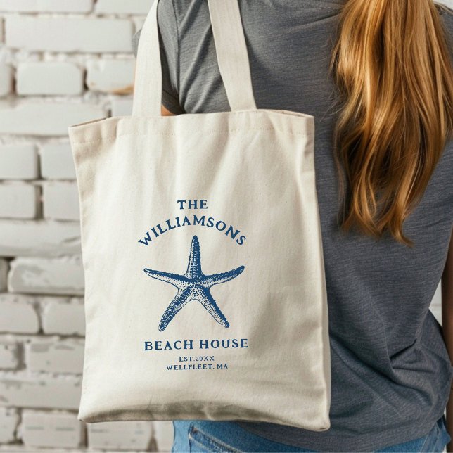 Custom Blue Coastal Starfish Beach House Tote Bag (A woman with long hair carries a cream tote bag featuring a blue starfish design.)