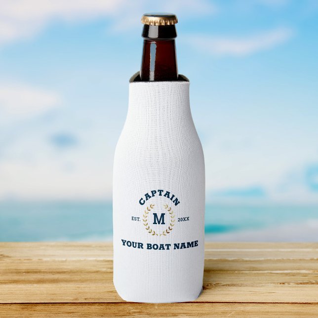 Custom Boat Captain Monogram Gold Laurel Nautical Bottle Cooler (Beer bottle in a white cooler with navy text "Captain Your Boat Name," on wooden surface)