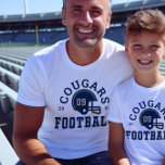 Custom Football Dad Navy Blue and Gold Team<br><div class="desc">Custom Front and Back Football T-Shirt for Dad - shown in White
Design for football dads features a football helmet with sporty text that can be customised for the team name,  son's last name,  and his jersey number. Gold and navy blue colours can be customised.</div>