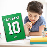Custom Green Last Name Sports Jersey Number  Notebook<br><div class="desc">Name,  number and drop shadow are customisable so you can make a sporty looking yet useful notebook unique and matching to your favourite sport team colours or room decor. Green background.</div>