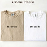 Custom Modern Minimalist Script Bride Bridesmaid T-Shirt<br><div class="desc">Celebrate your special day in style with this Personalised Bridesmaid T-Shirt, designed with a simple, stylish script and elegant calligraphy for a timeless minimalist look. This custom shirt is perfect for bridesmaids, the bride, and the entire wedding party, making it ideal for bachelorette parties, bridal showers, bridesmaid proposal gifts, and...</div>
