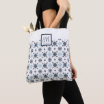 Custom Monogram Snowflake Tote Bag<br><div class="desc">Capture the magic of the season with our whimsical Monogram Snowflake Tote Bag, adorned with intricate blue and white snowflakes that dance across the design. Add your initial and name in the square at the top for a fun little touch for your Christmas, Hanukkah, or winter feel! Look for coordinating...</div>