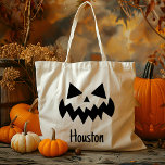 Custom Name Jack O Lantern Pumpkin Trick Or Treat Tote Bag<br><div class="desc">Celebrate Halloween in style with our Custom Name Jack O' Lantern Pumpkin Trick Or Treat Tote Bag! This charming tote features a classic jack o’ lantern design with a friendly pumpkin face, perfect for adding a festive touch to your child’s trick-or-treating adventures. Customisable with your child's name, this bag is...</div>