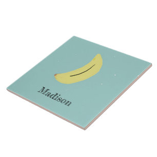 Custom name painted banana on blue ceramic tile