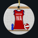 Custom Netball Uniform Red with Blue and White Ceramic Tree Decoration<br><div class="desc">A unique design for the netball player or netball fan with a netball uniform hanging up in a sports changing room in red with blue and white trim. The name and netball position can be customized for the netball player. A netball and water bottle is next to the netball uniform....</div>