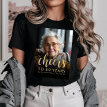 Custom Photo Cheers 80th Birthday Party<br><div class="desc">This 80th birthday party t-shirt features the guest of honour's photo with a gold-coloured text overlay. The word "cheers" appears in elegant gold-coloured calligraphy script, followed by "to 80 years" and the guest of honour's name and birthday in sans serif font. A dark screen helps make the text pop. A...</div>