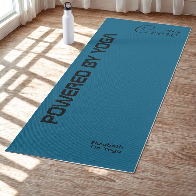 Custom Print Yoga Crew Ocean Blue Mat (Ocean blue yoga mat on a studio floor.)
