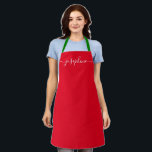 Custom Red Christmas Simple Elegant script Name Apron<br><div class="desc">Do you know someone who would love a personalised apron as she bakes those goodies, cooks delicious dishes in holiday colours (red and green). A perfect gift to encourage her talents on the holidays. Black script for the name with long-tail embellishments. Pro tip: keep the little square for the long-tailed...</div>