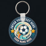 Custom Soccer Fan Text and Player Name Key Ring<br><div class="desc">For buyers who want more than a standard sports gift, this keychain offers a colorful soccer emblem built around your own wording. The artwork shows a central ball with energetic teal, orange, and cream swooshes, two side stars, small laurel shapes, and customizable top and bottom text areas displayed as “ENTER...</div>