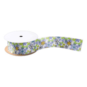 Cut paper snowflakes multicolored on white satin ribbon