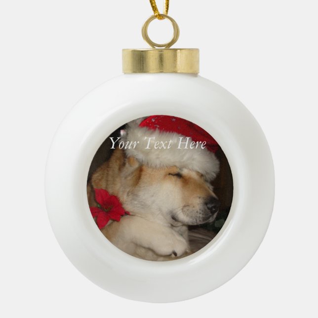 cute akita in christmas santa hat giving paw ceramic ball christmas ornament (Front)