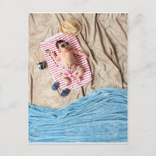 Cute baby relaxing at the beach postcard
