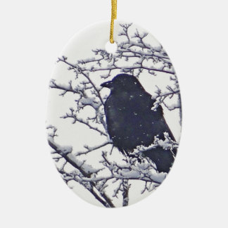 Cute black bird in snowy branches ceramic ornament