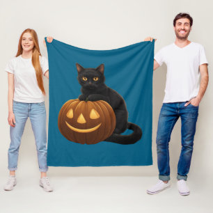 Cute black cat on a pumpkin fleece blanket