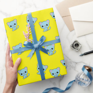 Cute bouncy blue kitten on yellow wrapping paper
