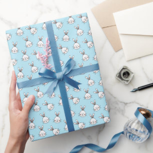 Cute bunny face pattern on light blue wrapping paper