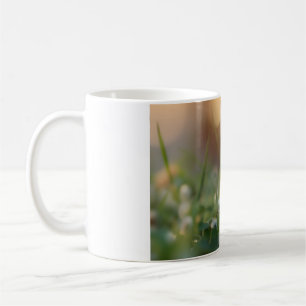 Cute bunny rabbit and a ladybug on the green field coffee mug