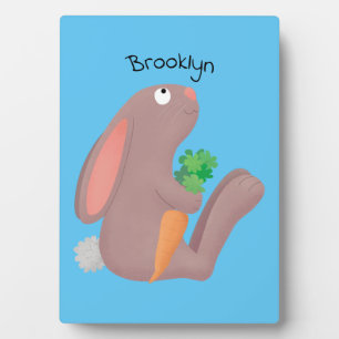Cute bunny rabbit sitting with carrot cartoon plaque