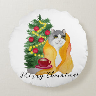 Cute cat under a cosy blanket with a cup of tea round cushion