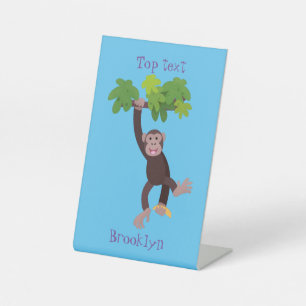 Cute chimpanzee in jungle hanging cartoon pedestal sign