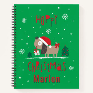 Cute Christmas dog with gift on green Notebook