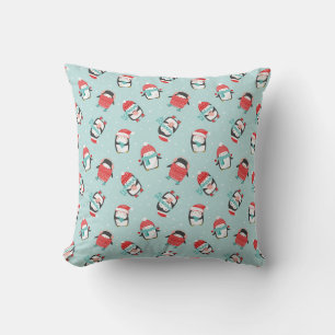 Cute christmas penguins on light blue cushion