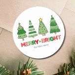 Cute Colourful Christmas Merry And Bright Classic Round Sticker<br><div class="desc">Wish everyone a very Merry Christmas with this cute and colourful Christmas Tree themed stickers featuring 'Merry & Bright' and 4 fun green Christmas Trees. You can change your family name or remove it if you prefer. The colour palette includes a cheerful mix of reds, pinks, and both dark and...</div>