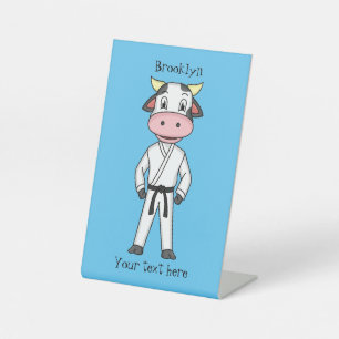 Cute cow in kung fu suit cartoon pedestal sign