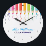Cute Custom Teacher Rainbow Artistic Classroom Large Clock<br><div class="desc">Beautiful line of coloured pencils leaving a pretty colourful squiggle streaked across the page in cute rainbow colours to decorate the top of this personalised wall clock. Customise with classroom decor with your name or other text in blue.</div>