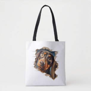 Cute dachshund puppy peeking in tote bag