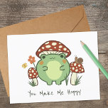 Cute Frog and Mushroom | You Make Me Hoppy  Card<br><div class="desc">This cute greeting card features a hand-drawn kawaii style cartoon frog,  wearing a mushroom hat,  along with other mushrooms,  a snail,  a flower,  a butterfly,  and grass. Text reads,  "You Make Me Hoppy" but can be customised,  if desired.</div>