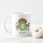 Cute Frog and Mushrooms Cottage Core | Name Coffee Mug<br><div class="desc">This cute, personalised mug features a hand-drawn kawaii style cartoon frog, wearing a mushroom hat, along with other mushrooms, a snail, a flower, a butterfly, and grass. A colour scheme of red, lime, green, brown, orange, yellow, and peach is perfect for either the Indie or Cottage Core Aesthetic lover. Original...</div>