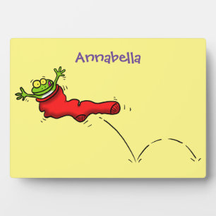 Cute frog in a red sock jumping cartoon plaque