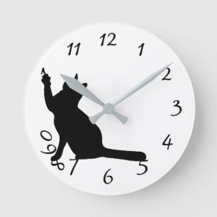 Cute funny black cat playing with numbers clock