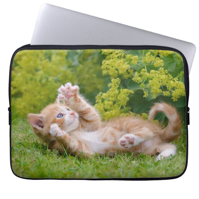 Cute funny cat kitten playing in a flowery garden  laptop sleeve (Front)