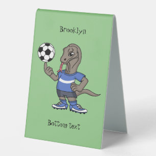 Cute funny Komodo dragon playing soccer cartoon