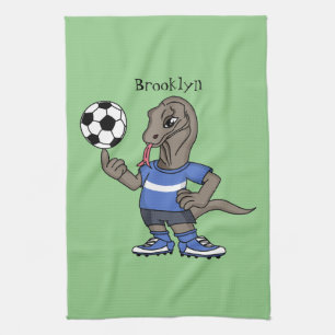 Cute funny Komodo dragon playing soccer cartoon Tea Towel