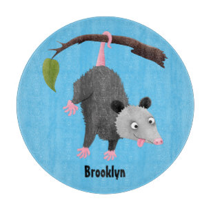 Cute funny opossum hanging from branch cartoon cutting board