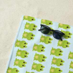 Cute green frogs on blue beach towel