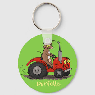 Cute happy cow driving a red tractor cartoon key ring