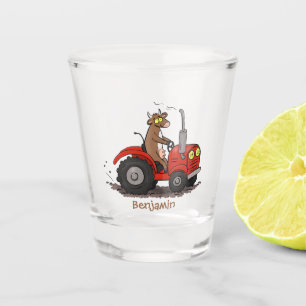 Cute happy cow driving a red tractor cartoon shot glass