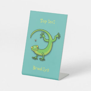 Cute happy green gecko greetings with bug cartoon pedestal sign