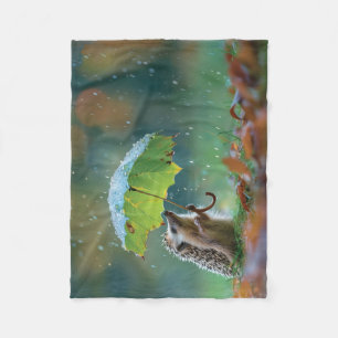 Cute hedgehog holding a leaf umbrella fleece blanket