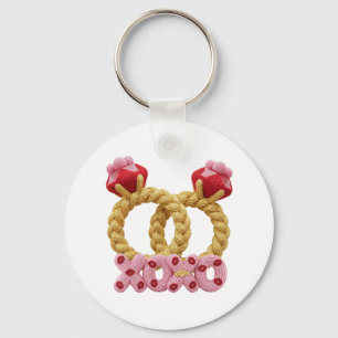 Cute intertwined knitted wedding rings with pink key ring