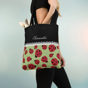 Cute ladybugs on green and custom name on black tote bag