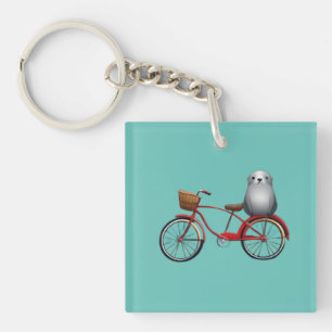 Cute little cartoon seal on a bicycle key ring