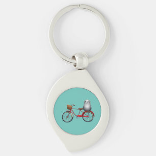 Cute little cartoon seal on a bicycle key ring