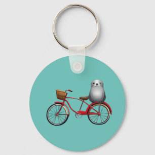 Cute little cartoon seal on a bicycle key ring